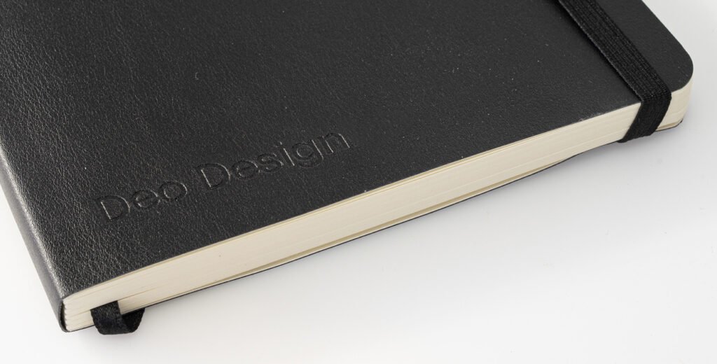 Closeup of a Flex notebook in black recycled cover with debossing logo